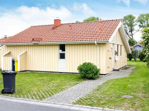 ein gelbes Haus mit rotem Dach in der Unterkunft 4 person holiday home in Otterndorf in Otterndorf