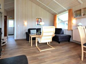 a living room with a table and a couch at Three-Bedroom Holiday home in Otterndorf 6 in Otterndorf