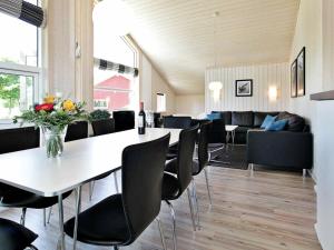 a dining room with a table and chairs at Three-Bedroom Holiday home in Großenbrode 7 in Großenbrode