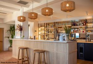 a bar in a restaurant with stools at Les Roches Brunes in Collioure