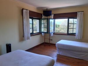 Een bed of bedden in een kamer bij Hotel Rústico Punta Uia