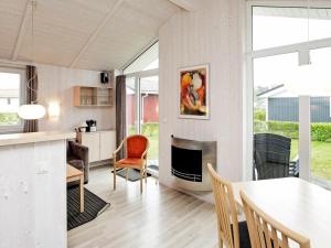 a kitchen and living room with a table and a fireplace at Two-Bedroom Holiday home in Grömitz 10 in Grömitz
