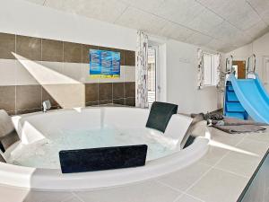 a large bath tub with a chair and a slide at 20 person holiday home in Hasselberg in Kappeln