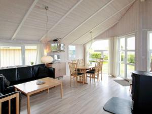 a living room with a couch and a table at 4 person holiday home in Gelting in Gelting