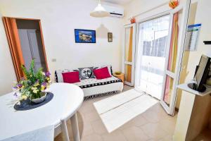 a living room with a couch and a table at SOLEMAREPONZA Casa Bougainvillea in Ponza