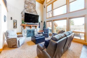 a living room with leather furniture and a fireplace at Northwest Passage Retreat in Sandpoint