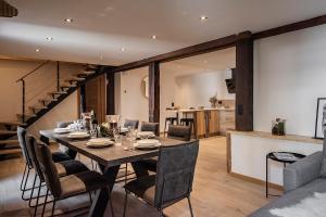 a dining room with a table and chairs at Nouveau et spacieux, Place de l'Eglise et terrasse privative in La Clusaz