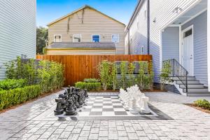 a chessboard on a patio with a fence at Hosteeva Modern Condo Near Magazine St & Close to FQ in New Orleans