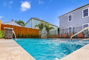 a swimming pool with a slide in a yard at Hosteeva Modern Condo Near Magazine St & Close to FQ in New Orleans