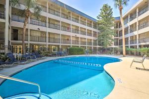 a swimming pool in front of a building at Coastal Condo with Pool and Direct Beach Access! in Hilton Head Island