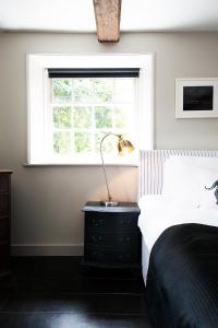 a bedroom with a bed and a window at The Ram Inn in Lewes