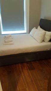 a bed with white pillows and a window in a room at Beautiful 2 Bedroom Ballsbridge Apartment near the Aviva in Dublin