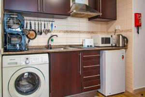 a kitchen with a washing machine and a washer at Bright Studio with Premium Amenities in Dubai