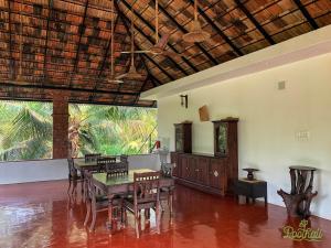 a dining room with a table and chairs at POOTHALI HOMESTAY in Nīleshwar