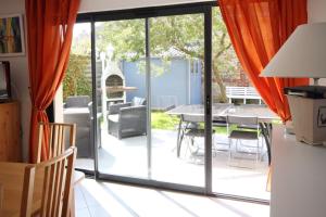 a dining room with sliding glass doors and a table at L'annexe in Fécamp