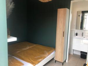 a small room with a bed and a cabinet at Nieboer in Vrouwenpolder