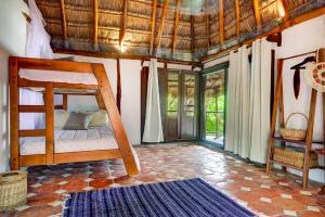 a bedroom with a bunk bed in a room at Beachfront bungalows- Soliman Bay in Tulum
