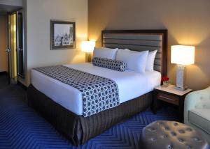 a hotel room with a large bed with two lamps at Crowne Plaza Princeton, an IHG Hotel in Princeton