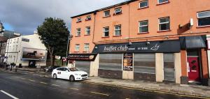 a white car parked in front of a building at Royal Chambers Liverpool in Liverpool