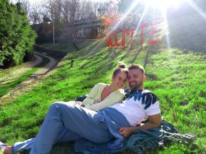 a man and a woman laying in the grass at Prirodna oaza Brvnare Platan in Vrdnik