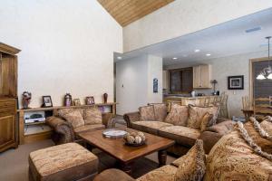 a living room with couches and a table at Evergreens 04 in Steamboat Springs