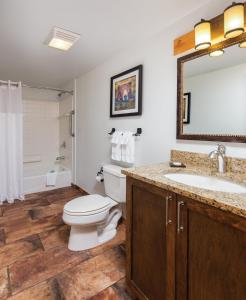 a bathroom with a toilet and a sink and a mirror at WorldMark Red River in Red River