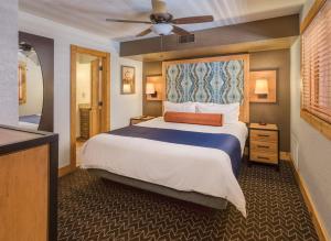 a bedroom with a large bed with a ceiling fan at WorldMark Red River in Red River