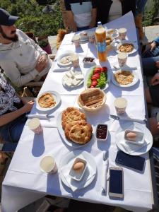 a long white table with food on it at Friends' Guesthouse & Hostel in Gjirokastër