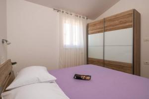 a bedroom with a bed with a purple floor and a bottleasteryasteryasteryastery at Villa Ester in Pula +48 photos