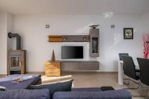a living room with a couch and a tv at Villa Ester in Pula