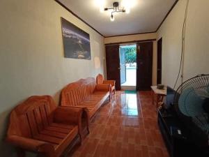 a living room with two couches and a table at La Frezza Beach House in Bayawan