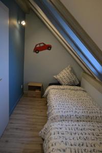 a bedroom with a bed with a car on the wall at Gîtes au pied du Haut-Koenigsbourg in Kintzheim +2 photos