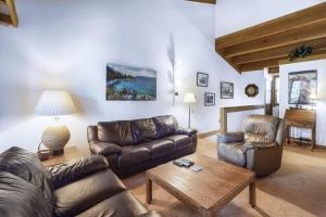 a living room with leather couches and a coffee table at Northstar Gold Bend Retreat in Truckee