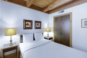 a bedroom with a white bed and two lamps at Northstar Gold Bend Retreat in Truckee +20 photos