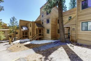 a wooden house with a tree in front of it at Northstar Gold Bend Retreat in Truckee