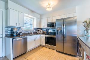 a kitchen with stainless steel appliances and white cabinets at Casa Del Marina 111 in Orange Beach