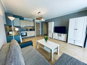 a living room with a couch and a table at Kisfaludy Residence in Balatonfüred