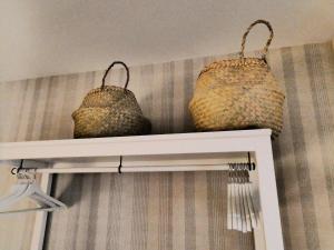 two baskets sitting on a shelf in a room at Logrocity Corazon de Logroño PARKING PRIVADO GRATIS in Logroño