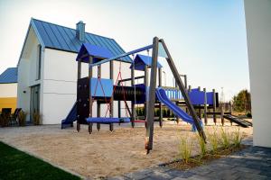 a playground with a slide in front of a building at Dream-House in Kopalino