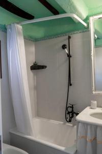 a bathroom with a white tub and a sink at Solemagia in Vernazza