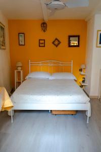 a bed in a bedroom with an orange wall at Solemagia in Vernazza