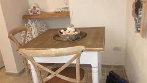 a table with a bowl of fruit on top of it at Romì-Antica dimora in Polignano a Mare +7 photos