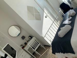 a room with a staircase with a bed and a mirror at Corniglia Dreams in Corniglia
