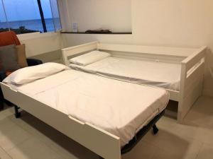 A bed or beds in a room at Beach Front Apartment-1st Line