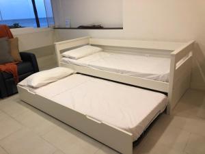 A bed or beds in a room at Beach Front Apartment-1st Line