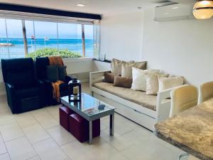 A seating area at Beach Front Apartment-1st Line