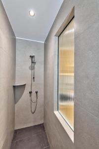 a bathroom with a shower with a large mirror at Aeolia Boutique Studios in Ermoupoli