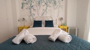 a bedroom with a bed with towels on it at AZAHAR-Playa Home by Cadiz4Rentals in Cádiz