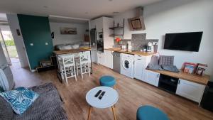 a kitchen and living room with a table and chairs at Vacances Ô Loch - Studio à 200 mètres de la plage - Le Cap Coz Fouesnant in Fouesnant +30 photos