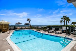 a swimming pool with a view of the ocean at The Beverley Beach House in Myrtle Beach